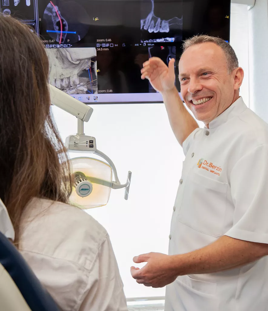 Dr. Berzin explaining dental procedure to patient